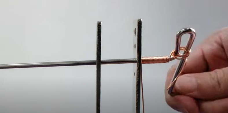 Wind the wire against the metal bar to create a compact wire coil